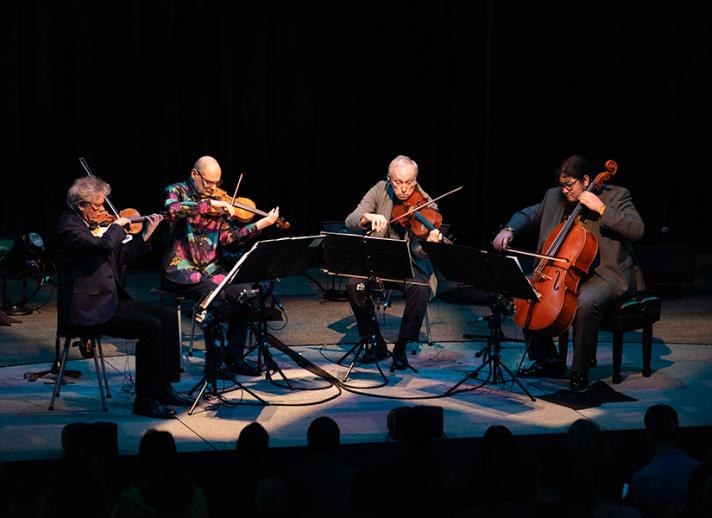 Kronos Quartet performing live on stage for their "Five Decades" tour
