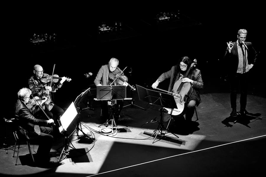 Members of Kronos Quartet engaged in performance on stage