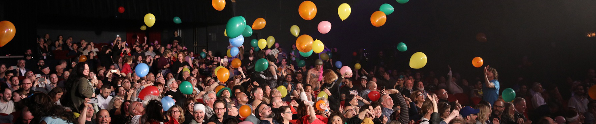 Audience enjoying balloons above their heads