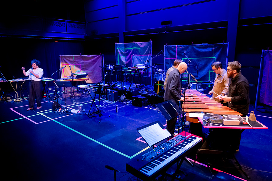 Sō Percussion members performing with instruments on stage