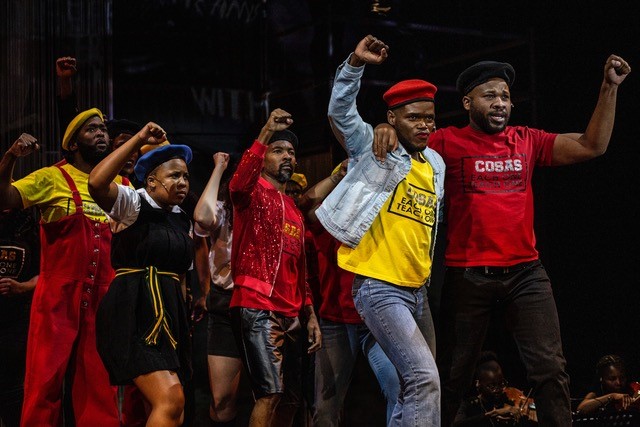 Performers on stage simulating protest march in Nkoli: A Fierce and Fabulous Life