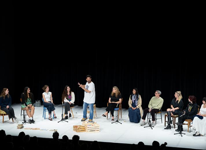 Tiago Rodrigues on stage with audience members for "By Heart"