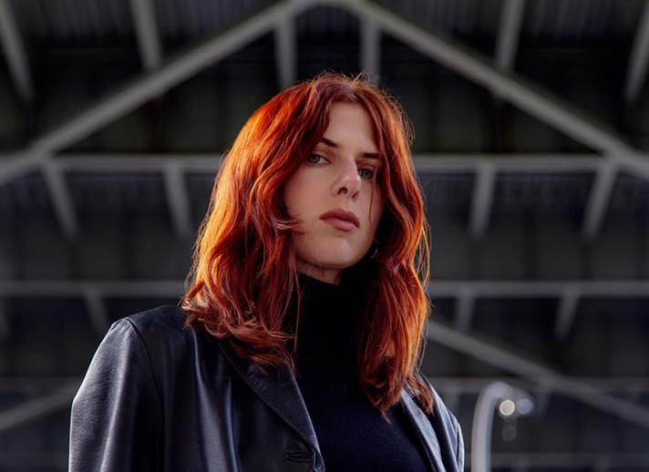 Laurel Halo portrait in front of geometric background