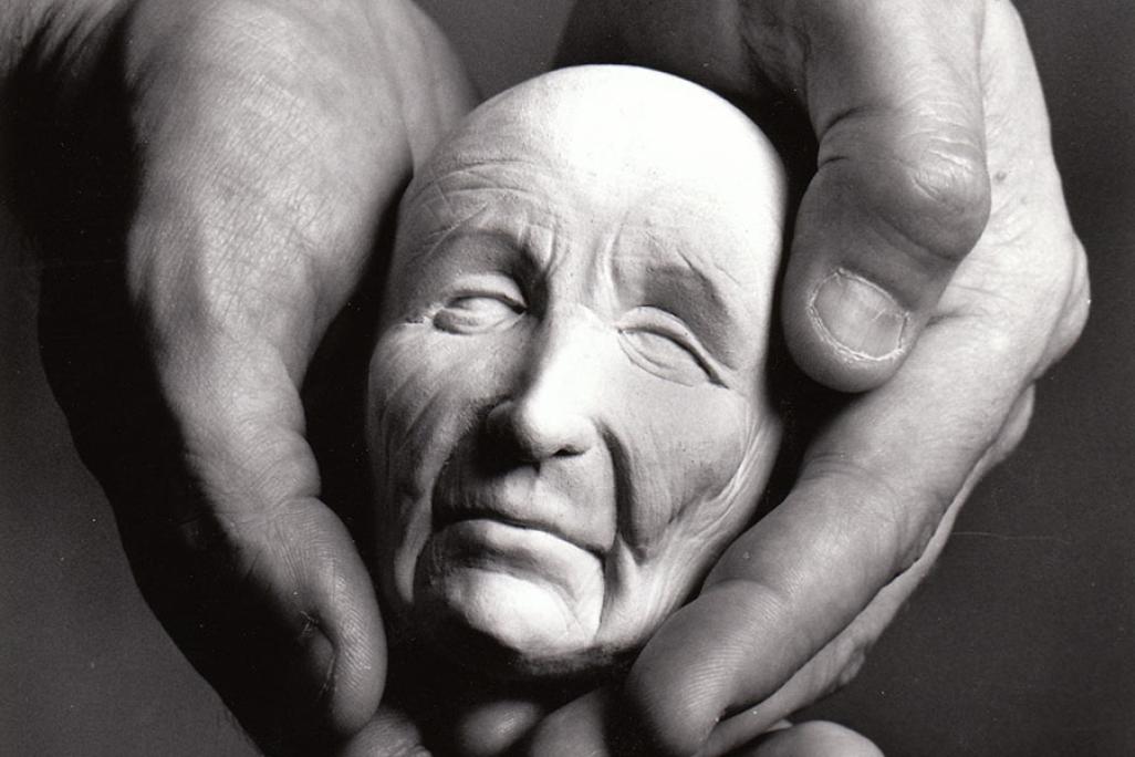 Close up of hands holding a fake head