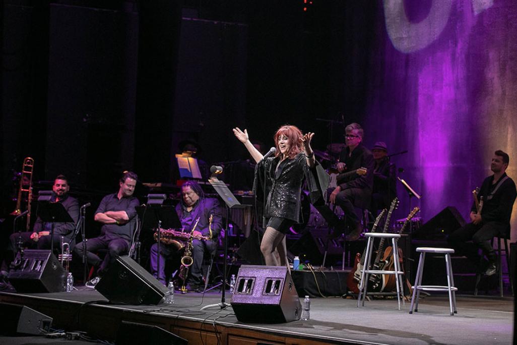 Beth Lapides performs on stage