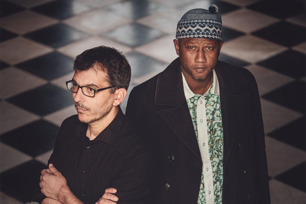 Ablaye Cissoko & Cyrille Brotto stand on a checkered floor
