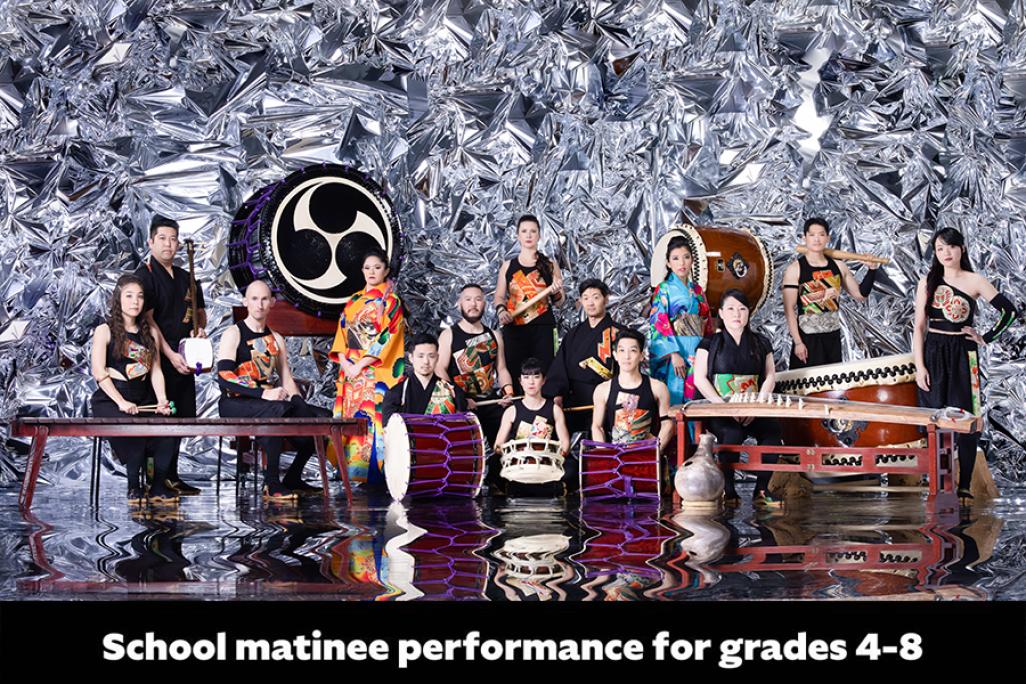 Members of TAIKOPROJECT posing for group shot with large instruments