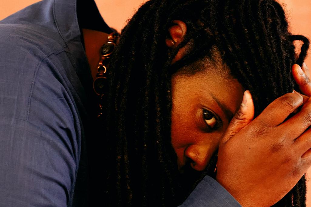 intimate, up close portrait image of Jlin laying on left side