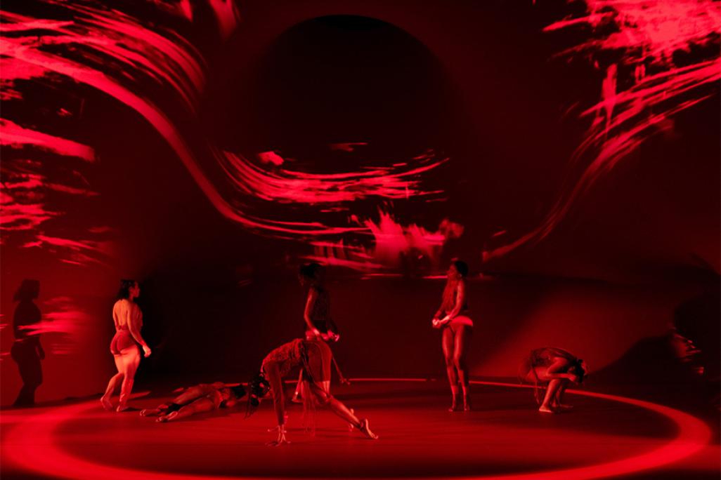 dancers performing on stage for Shamel Pitts | TRIBE "Marks of Red" in red backdrop
