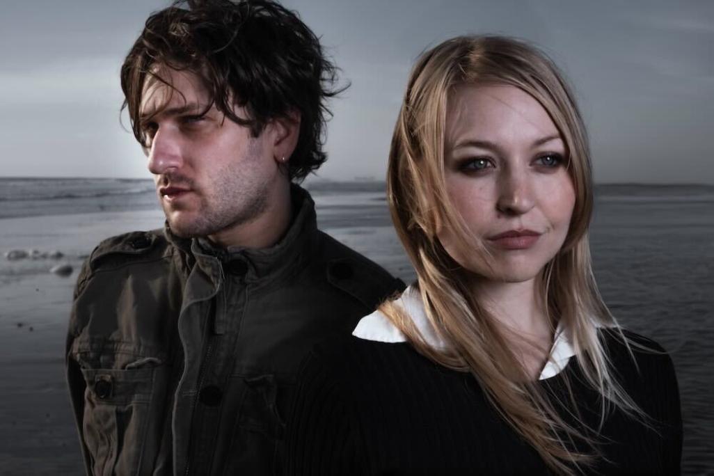 Photo of members of After posed in front of an overcast sea backdrop