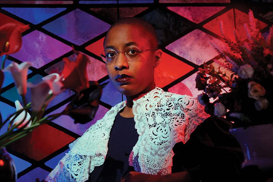 Cécile McLorin Salvant stands in front of stained glass windows