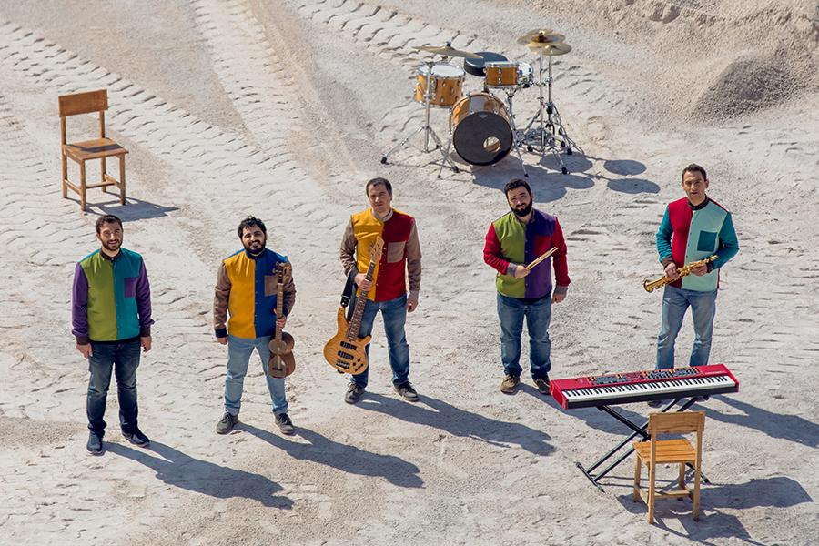 MVF Band stands in a desert while wearing colorful outfits