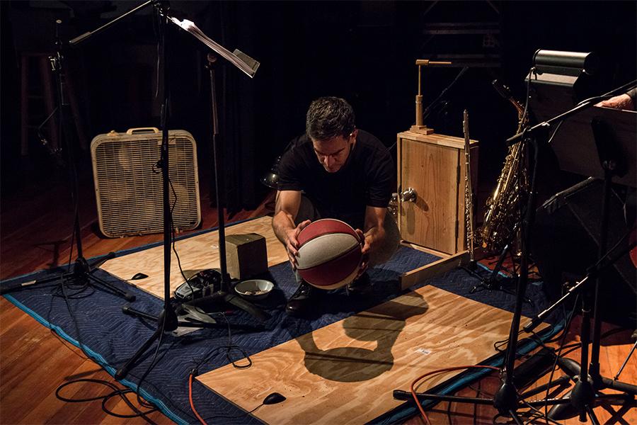 Dan Froot uses a basketball to create foley noises on a soundstage