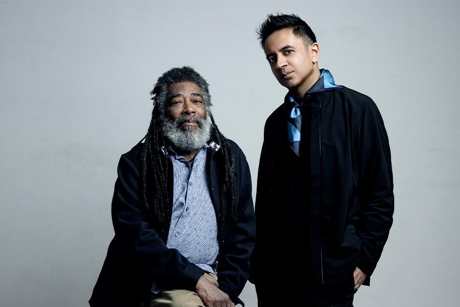 Vijay Iyer and Wadada Leo Smith pose in front of a grey background