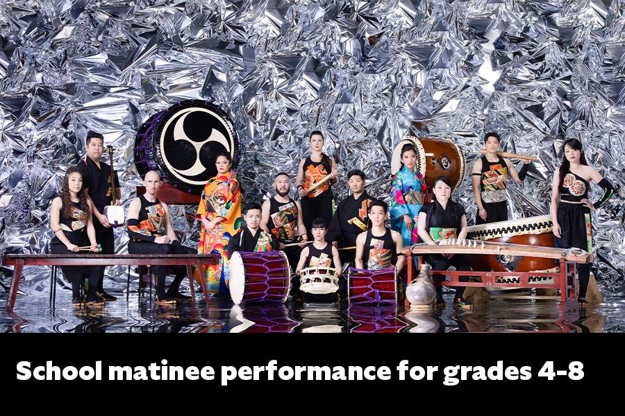 Members of TAIKOPROJECT posing for group shot with large instruments and silver background