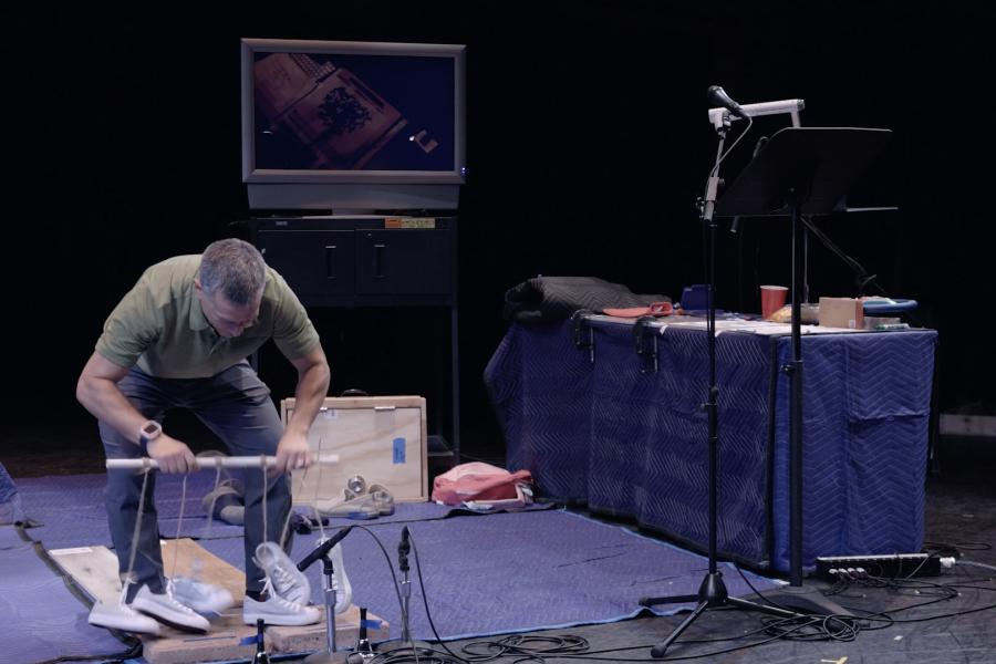 Dan Froot uses shoes to create foley noises on stage live