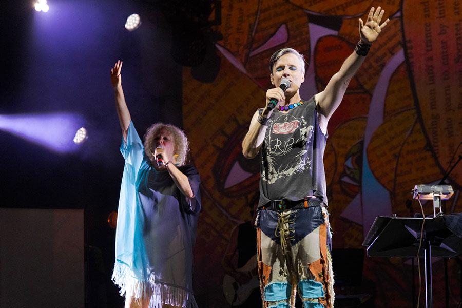 John Cameron Mitchell and Amber Martin singing with their arms up