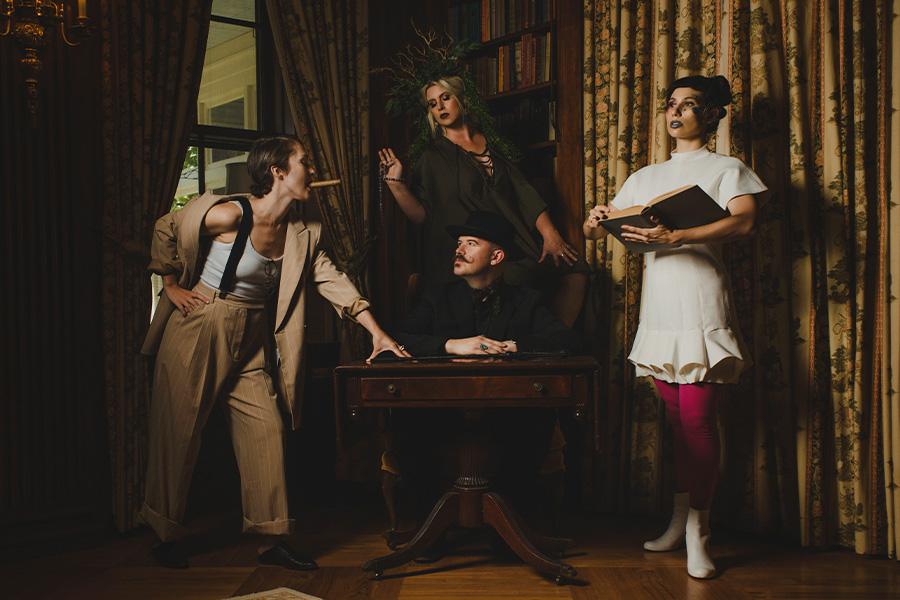 performers of Roomful of Teeth in a library corner candidly posing