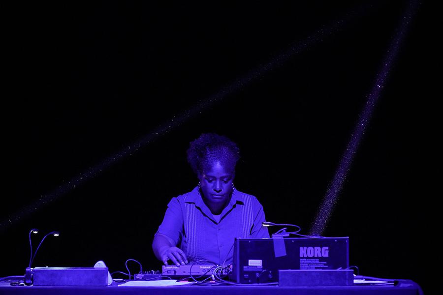 Yvette Janine Jackson performing with electronic equipment with blue lighting