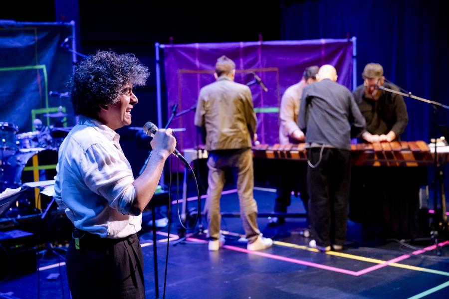 Helado Negro and Sō Percussion members performing on stage