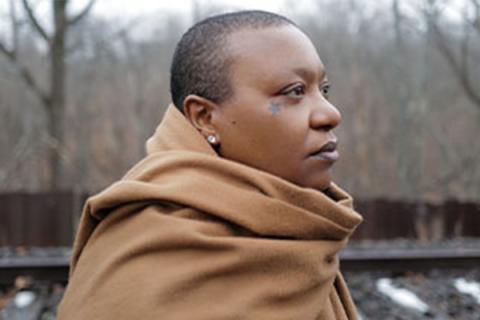 Meshell Ndegeocello stands outdoors