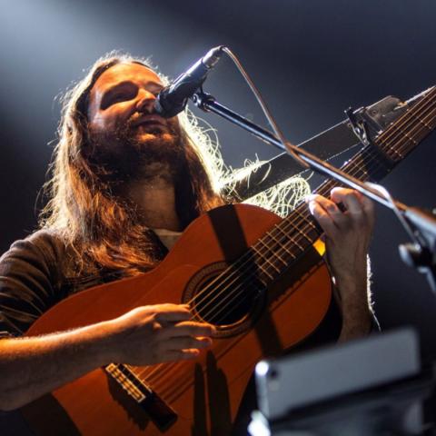 Nano Stern sings into a microphone on stage