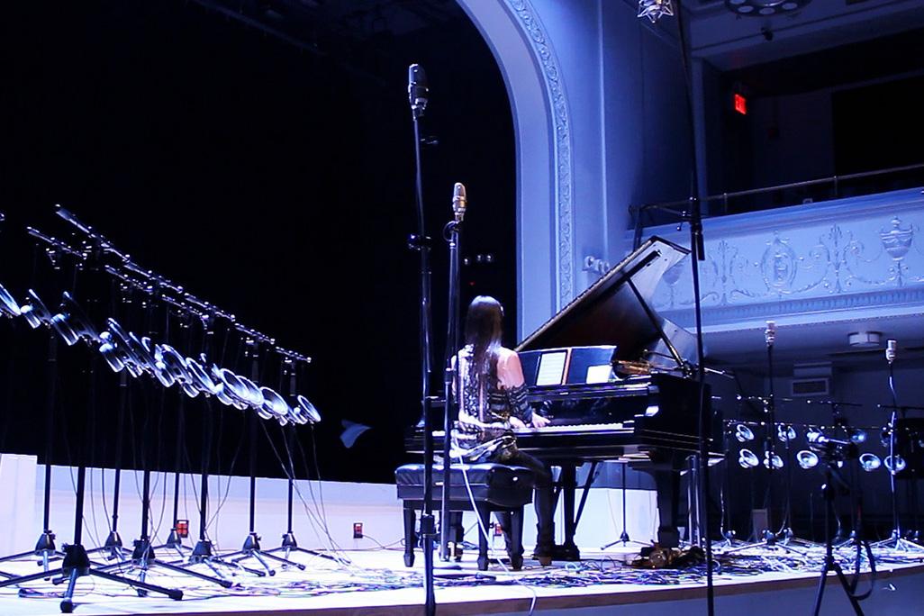 Vicky Chow performs on stage with 40-channel 1-bit electronics surrounding her