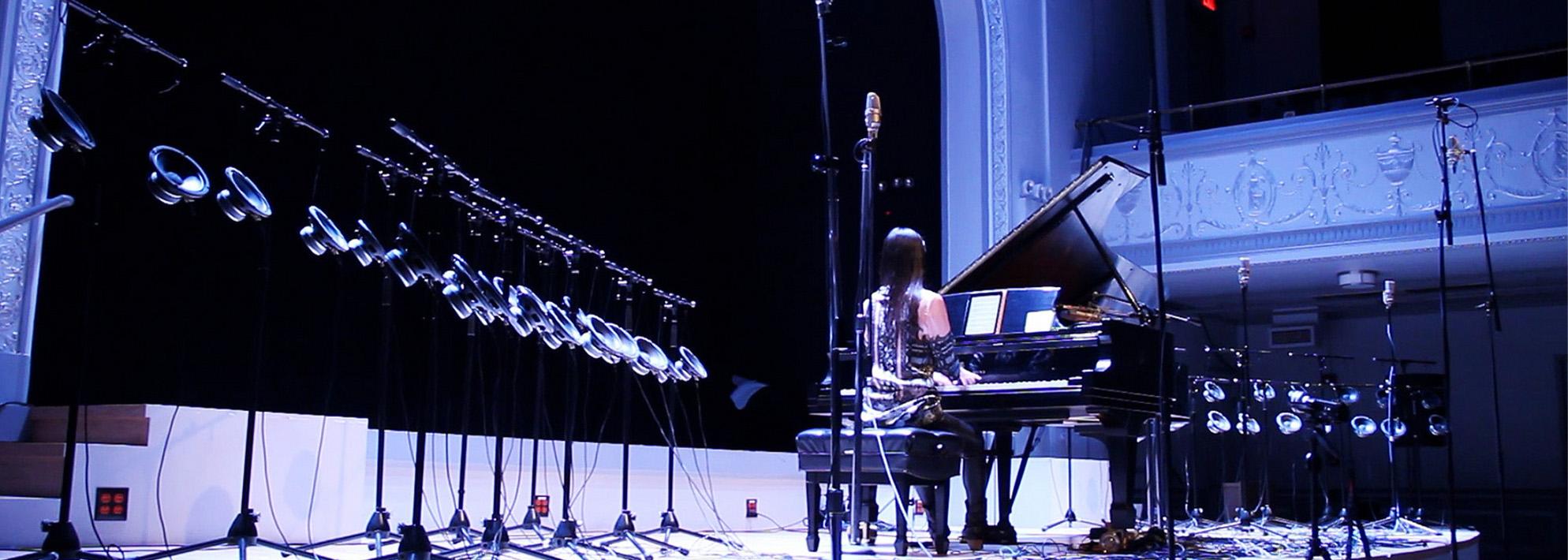 Vicky Chow performs on stage with 40-channel 1-bit electronics surrounding her