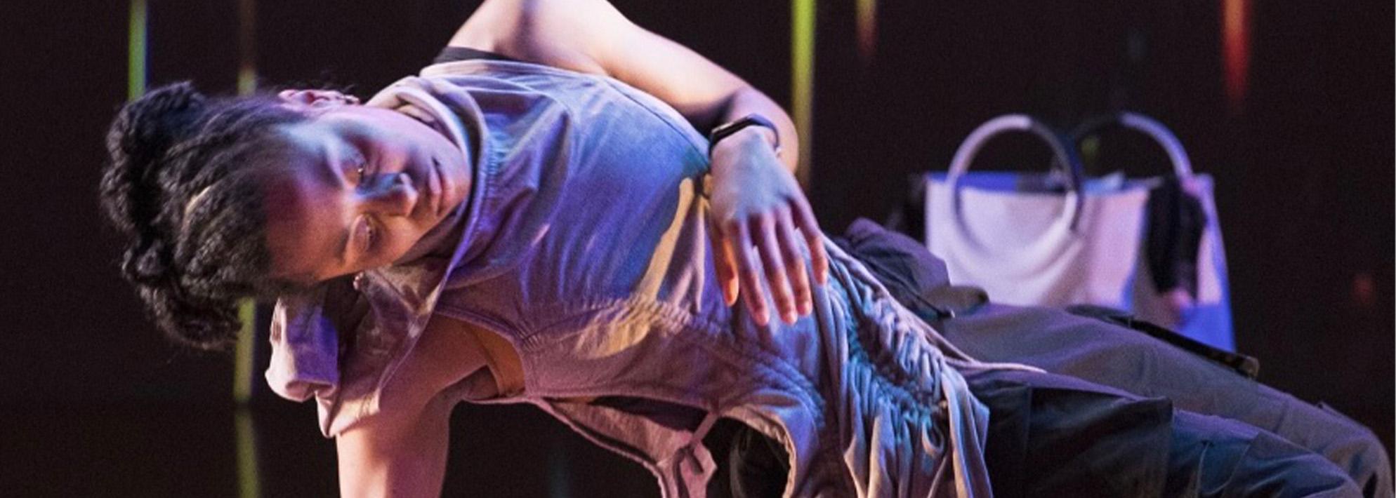 Kyreeana Breelin Alexander leans backward in a dancing pose on stage