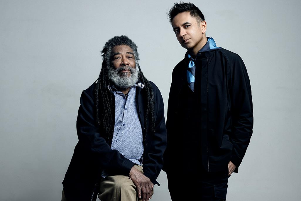 Wadada Leo Smith and Vijay Iyer pose in front of grey backdrop
