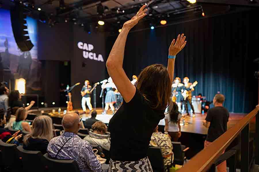 Audience member dancing and enjoying a performance at The Nimoy