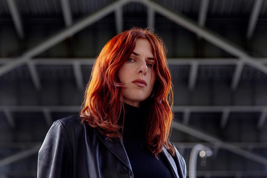 Laurel Halo portrait in front of geometric background